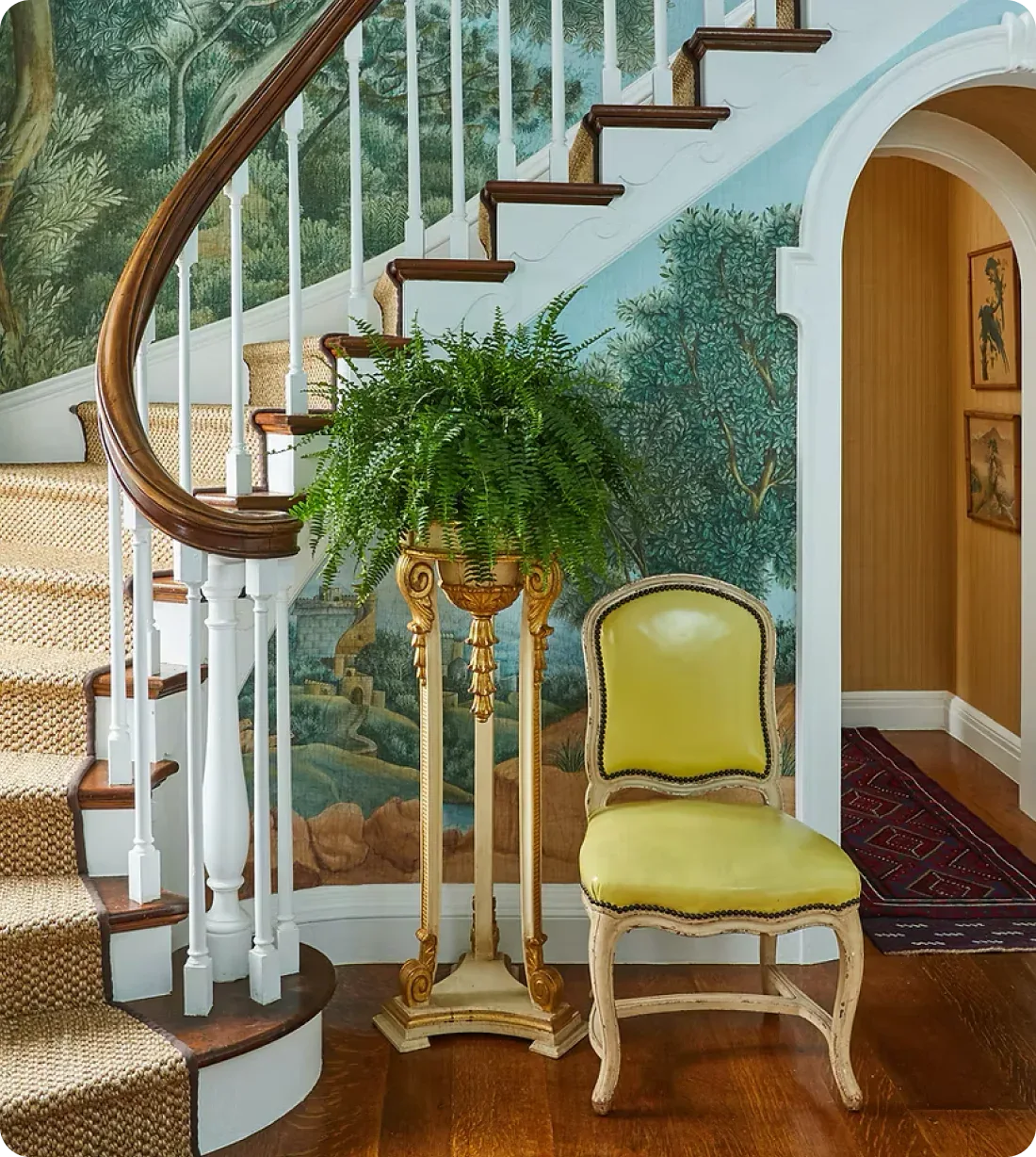 Staircase with a green plant and yellow chair in a decorated room