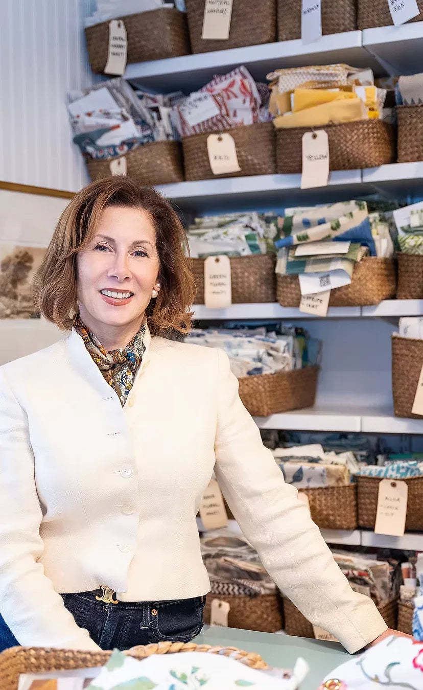 Woman standing in a store with shelves stocked with various items